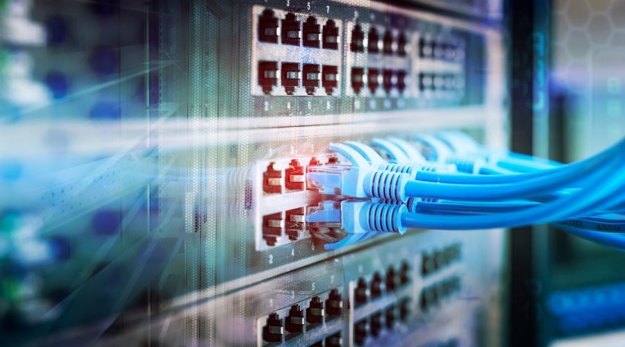 Close-up of network cables connected to a data center switch.