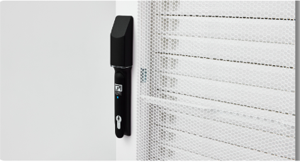 Black electronic lock mounted on a white server cabinet door.