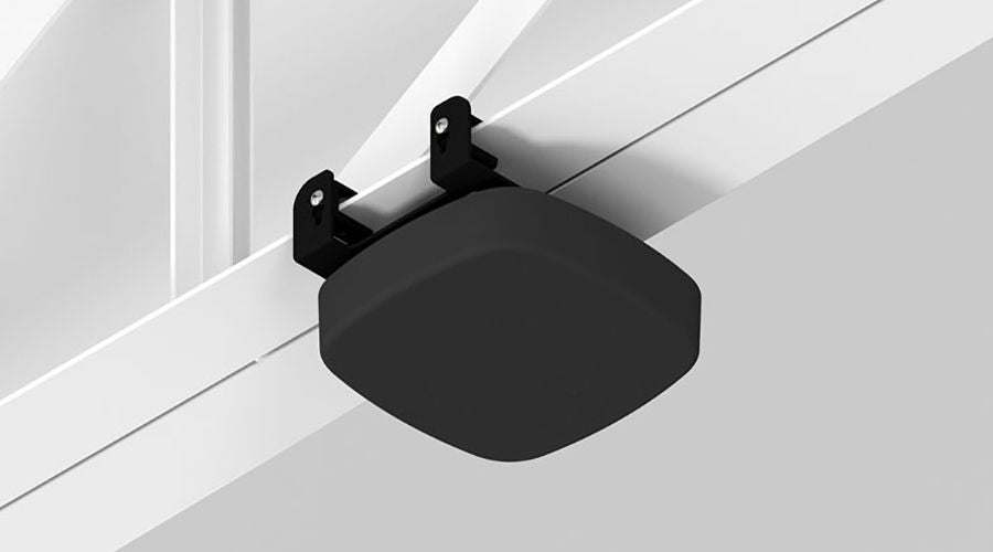  A black wireless access point enclosure mounted on a ceiling beam.