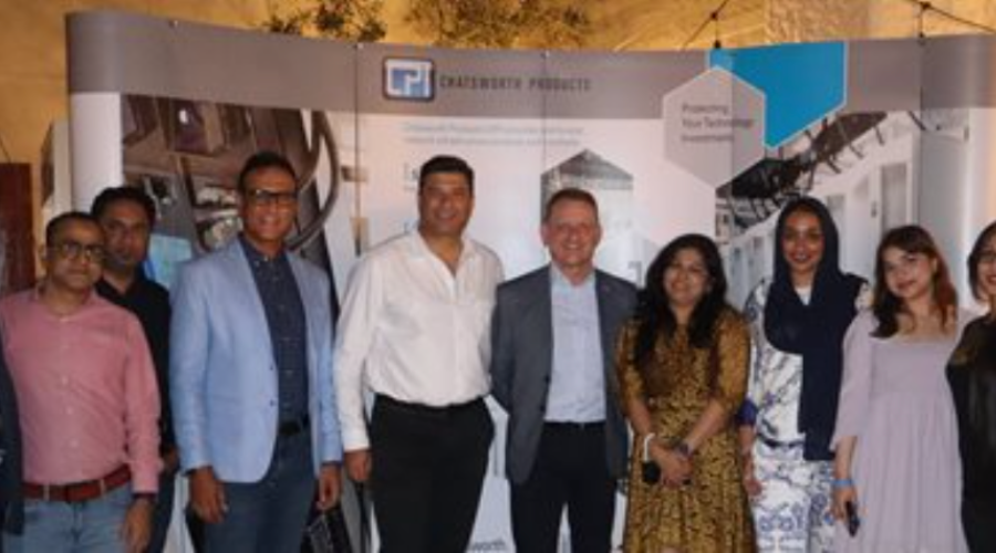 Group of people posing in front of a Chatsworth Products display.