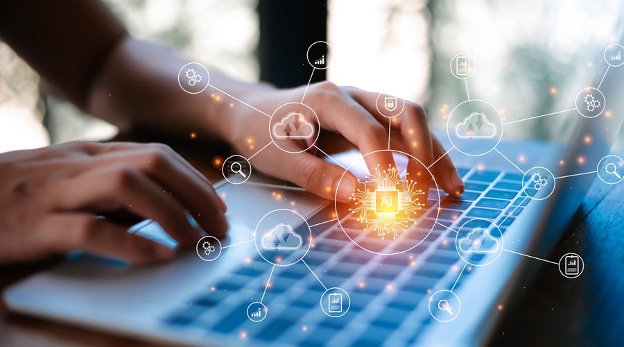 Hands typing on a laptop with AI and cloud icons around.
